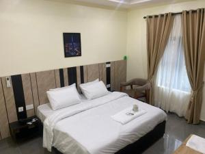Postel nebo postele na pokoji v ubytování Victia Suite and Lounge