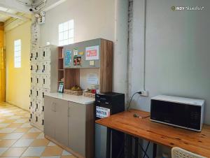 a kitchen with a counter and a microwave on a table at haonornhostel in Ban Madua Wan +3 photos