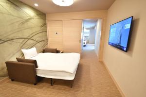 Odysis Suites Osaka Airport Hotel的电视和/或娱乐中心