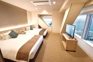 Odysis Suites Osaka Airport Hotel客房内的一张或多张床位