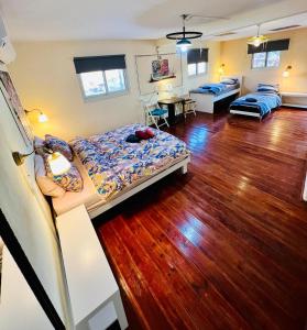 a bedroom with a bed and a wooden floor at Chen in Ezuz - Adults Only in ‘Ezuz +56 photos