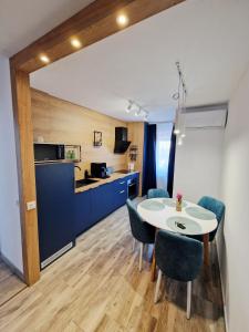 a kitchen and dining room with a table and chairs at SaraHome Turda in Turda