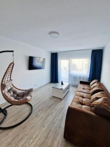 a living room with a couch and a chair at SaraHome Turda in Turda