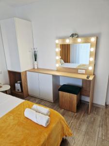 a bedroom with a dressing table and a mirror at SaraHome Turda in Turda