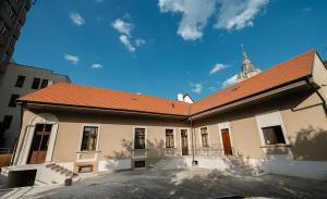 a large building with a red roof on a street at Villa Botar in Cluj-Napoca