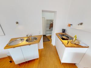 a kitchen with two sinks and a wooden counter at Seehütte - 304 in Cuxhaven