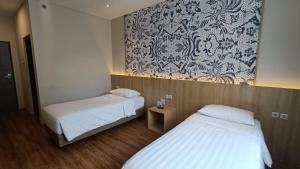 Postel nebo postele na pokoji v ubytování Adia Suites Hotel