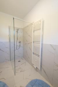 a bathroom with a shower with a glass door at Fernblick in Sluderno +13 photos