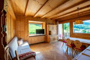 a living room with a couch and a table with chairs at Fernblick in Sluderno