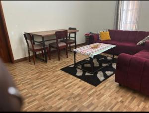 a living room with a couch and a table at Katabi Green Escape in Entebbe