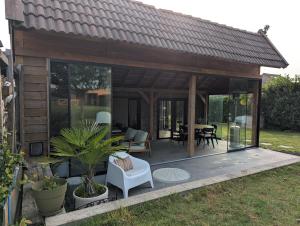 a pavilion with a table and chairs in a yard at Vacation on the farm in Lanaken