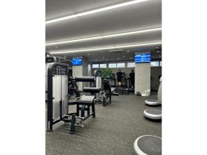 a gym with treadmills and machines in a building at Nakatsu Sunrise Hotel - Vacation STAY 64769v in Nakatsu