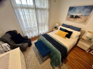 a bedroom with a bed and a chair in it at Sunshine Three in Salisbury