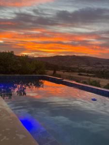a swimming pool with a sunset in the background at Dar Charkaoui in Tetouan +12 photos