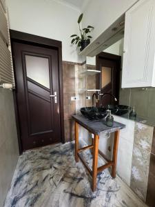a bathroom with two sinks and a wooden door at Za Rogiem in Sandomierz