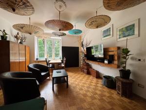 a living room with a television and a table and chairs at Za Rogiem in Sandomierz +13 photos