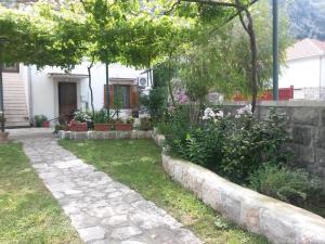 a garden in front of a house at Apartments Grgurević in Kotor