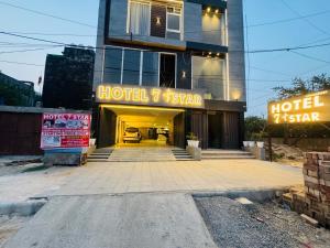 a hotel star with a car in the garage at Hotel 7 Star Rohini Sector 22 in New Delhi