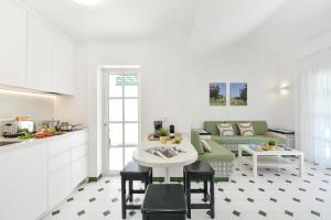a kitchen and living room with a table and a couch at Campo Golf 68 by VillaGranCanaria in Las Palmas de Gran Canaria