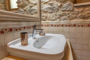 a bathroom with a white sink and a mirror at Ξενώνας Πελασγός in Sparti +29 photos
