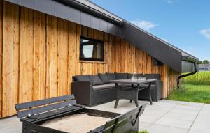 a patio with a couch and a table and a building at 3 Bedroom Awesome Home In Tarm - P52739 in Tarm +17 photos