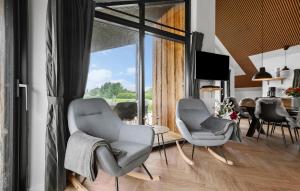 a living room with two chairs and a table at 3 Bedroom Awesome Home In Tarm - P52739 in Tarm