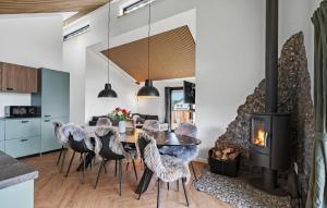 a dining room with a fireplace and a table and chairs at 3 Bedroom Awesome Home In Tarm - P52739 in Tarm