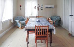 a dining room with a table and chairs at 4 Bedroom Cozy Home In Mandal - Nvk242 in Ime