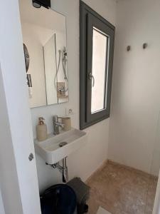 a bathroom with a sink and a mirror at Libertà Home in Trapani