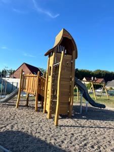 a playground with a slide in the sand at seacottage7008 in Knokke-Heist