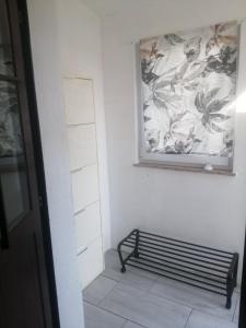 a hallway with a bench and a painting on the wall at Pipilota in Rijeka