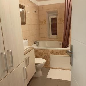 a bathroom with a toilet and a tub and a sink at Pipilota in Rijeka