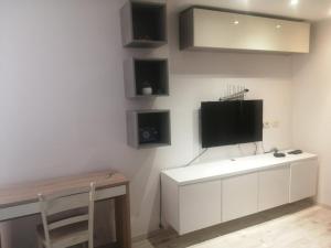 a living room with a tv on a wall at Pipilota in Rijeka