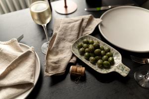 a table with plates and a bowl of green grapes at Moment Blythswood St in Glasgow