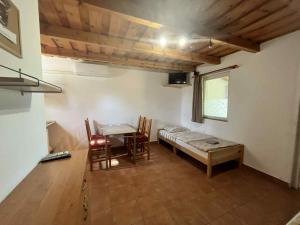 a room with a table and a bed and a dining room at Márice Vendégház in Siklós
