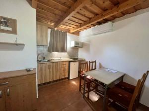 a kitchen with a table and a dining room at Márice Vendégház in Siklós