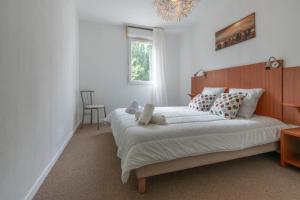 a bedroom with a large bed with a wooden headboard at Auréva - Piscine - Jardin - parking - Aix in Fuveau