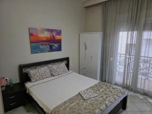 a bedroom with a bed and a large window at Vasilis & Nikolas Studios in Limenas
