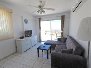 a living room with a couch and a table at Villa Sunshine in Pissouri