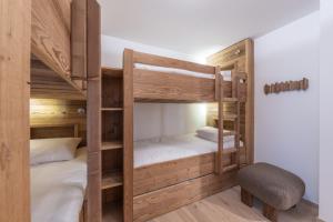 a bunk bed room with two bunk beds and a chair at Le Refuge du Pic in L'Alpe-d'Huez