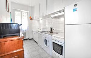 a kitchen with a white refrigerator and a dishwasher at 2 Bedroom Nice Home In Port Vendres - Flp294 in Port-Vendres