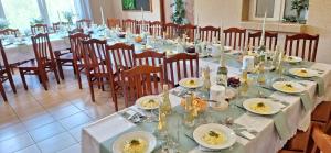 une salle à manger avec une longue table et des chaises dans l'établissement Willa Monika, à Muszyna
