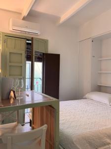 a bedroom with a bed and a counter with a table at Prieto Picudo - Harbor's Light in Villajoyosa
