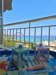 a view of the beach from the balcony of a hotel at Eva's sweet house in Paleo Tsifliki