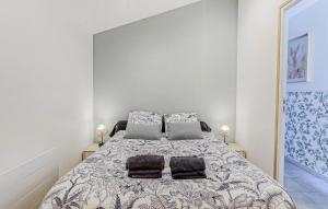 a bedroom with a large bed with two pillows at Jolie Maison Proche Plage in Le Crotoy +18 photos