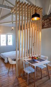 a room with a table and chairs and a bed at Stone residence across Eiffel's Tower - Filiatro 3 in Filiatra