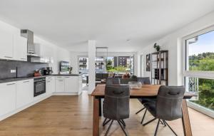 a kitchen and dining room with a table and chairs at Gebirgsresort Winterberg in Winterberg