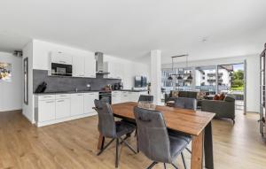 a kitchen and dining room with a wooden table and chairs at Gebirgsresort Winterberg in Winterberg