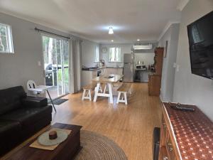 a living room with a couch and a table and a kitchen at 75 Peace Street in Denmark