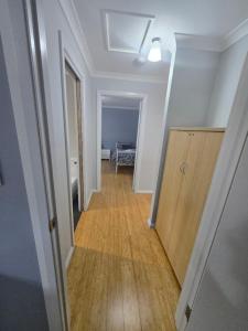 a hallway leading to a room with a wooden floor at 75 Peace Street in Denmark